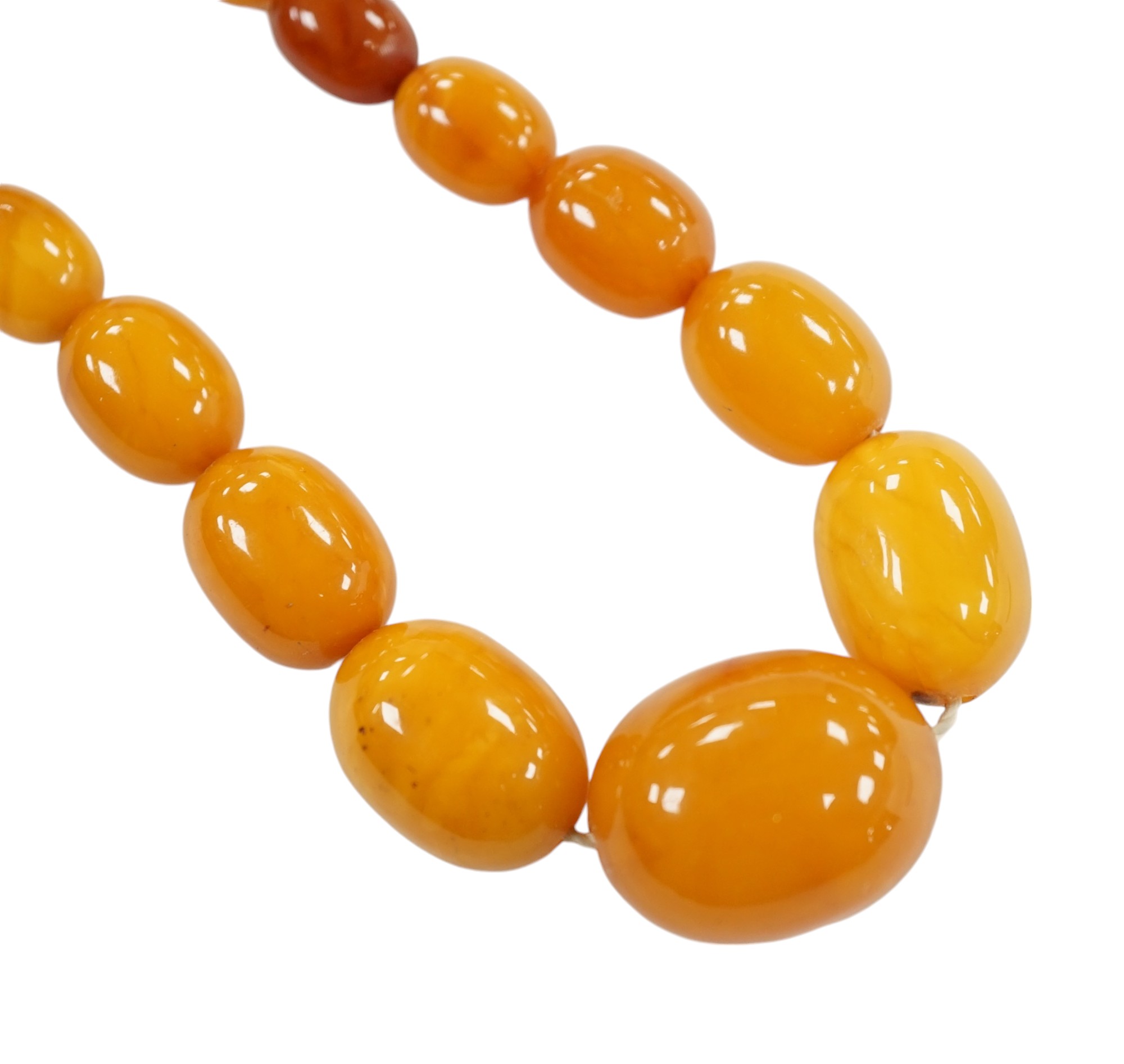 A single strand graduated oval amber bead necklace, 42cm, gross weight 23 grams. Condition - poor to fair